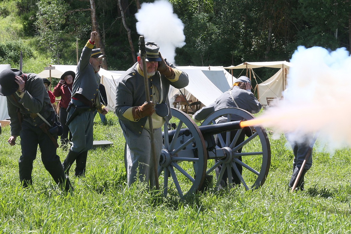 Athol resident Larry Hughes, along with his son, Gabe, daughter Natalie, and friends, covered their ears when their cannon from the 14th Virginia Cavalry roared at the Battle of Deep Creek May 26. (JUDD WILSON/Press)