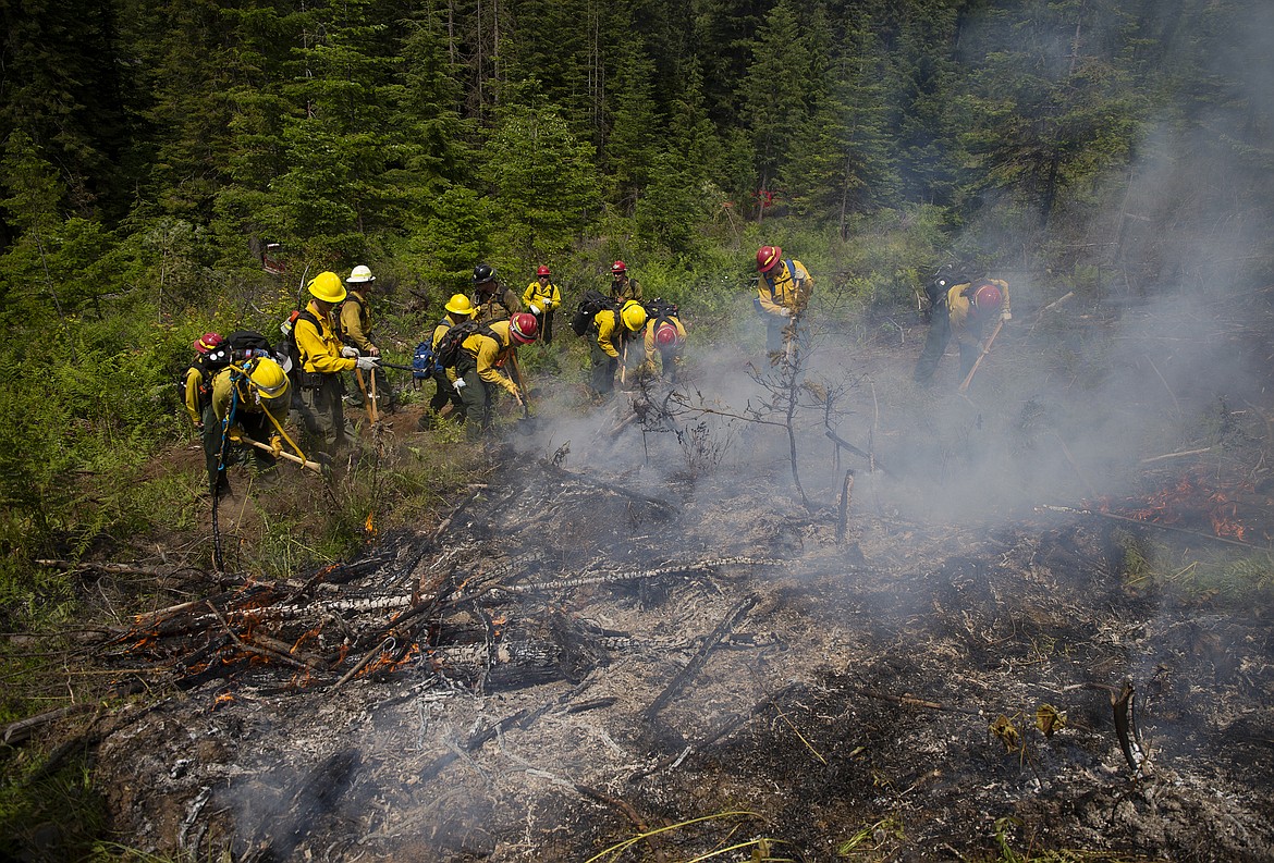 Wildland firefighters in training dig a line around a small controlled burn Thursday afternoon south of Coeur d&#146;Alene.