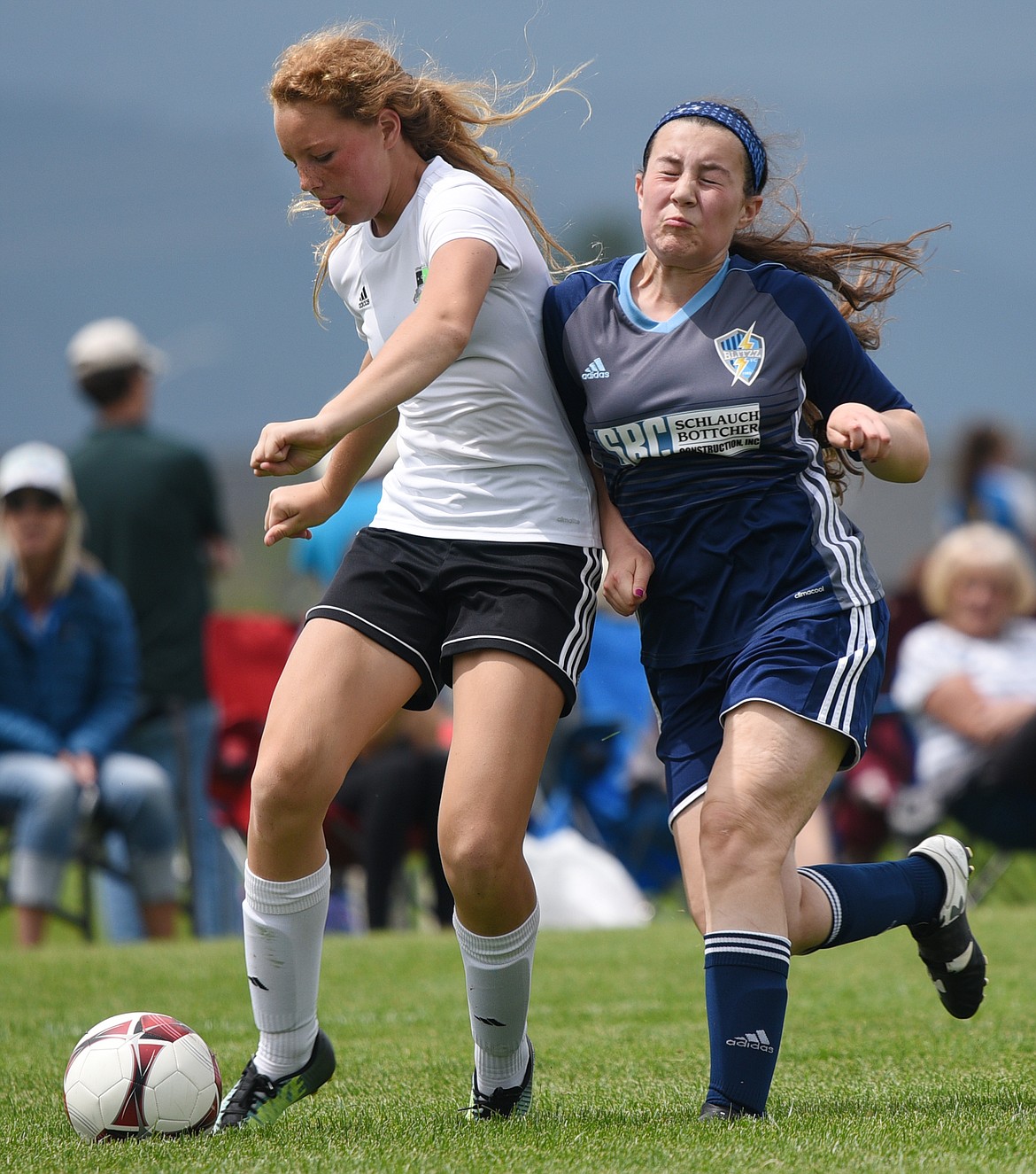 Flathead Valley United White 2003's Tallory Workman gets bumped as she shoots by Blitzz FC Blue 2004's Kaylee Cannan in the second half during the Montana State Cup at Kidsports Complex on Saturday. (Casey Kreider/Daily Inter Lake)