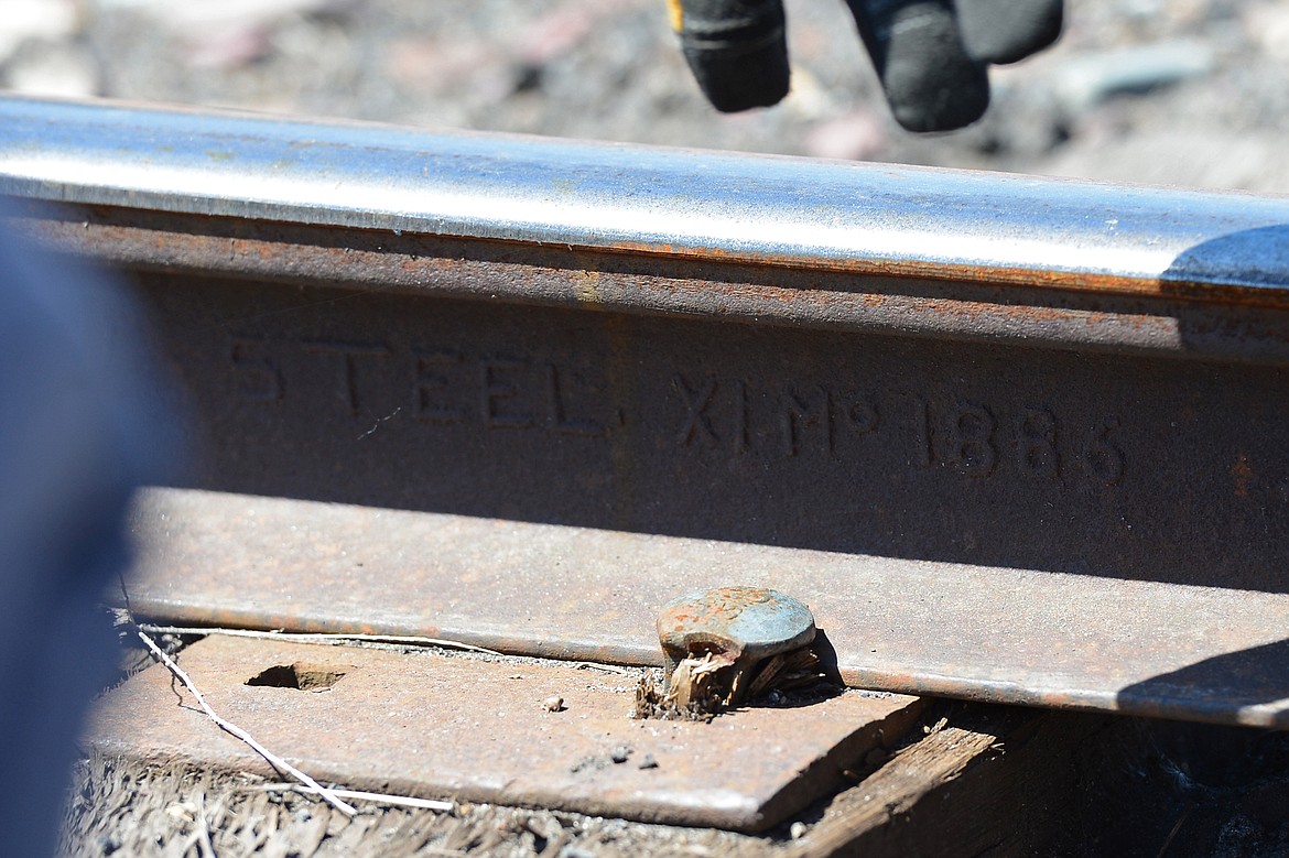 Railcar operator Bill Phoenix points to a section of track that was made in 1886 during a railcar tour through the Kalispell Core Area on Thursday. (Casey Kreider/Daily Inter Lake)