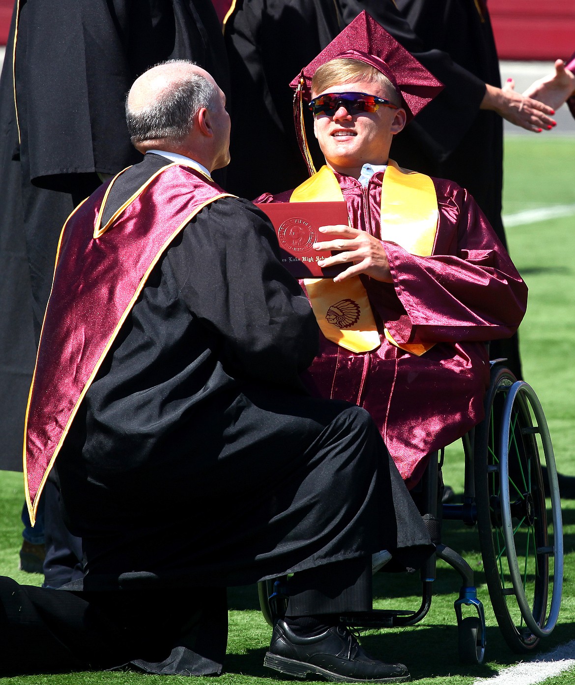 Rodney Harwood/Columbia Basin HeraldMoses Lake senior Spencer Kimbro receives his diploma on Saturday at Lions Field. Kimbro is headed to the University of Alabama next fall on a wheelchair basketball scholarship.