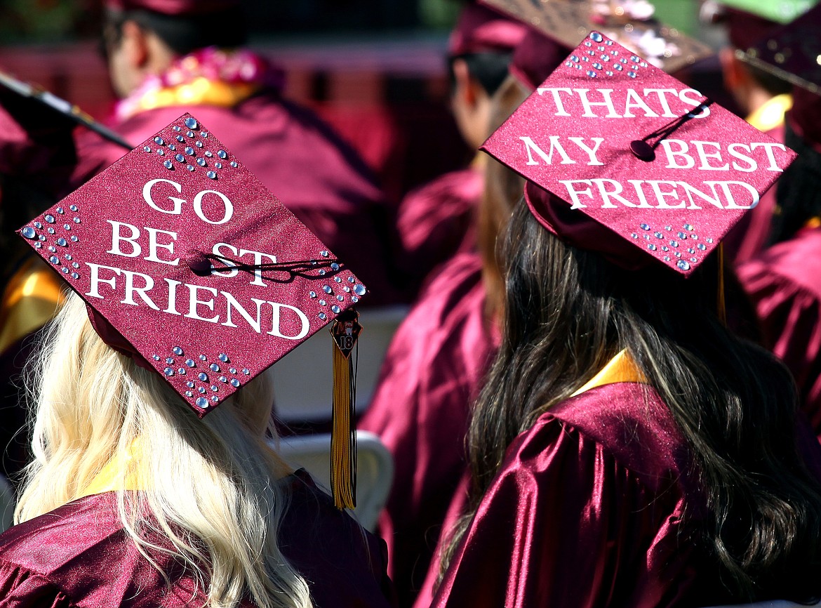 Rodney Harwood/Columbia Basin HeraldFor some Moses Lake graduates, they have guilt lasting relationships and friendships over the years. These two young women took the time to make that known during Saturday's graduation ceremonies at Lions Field.