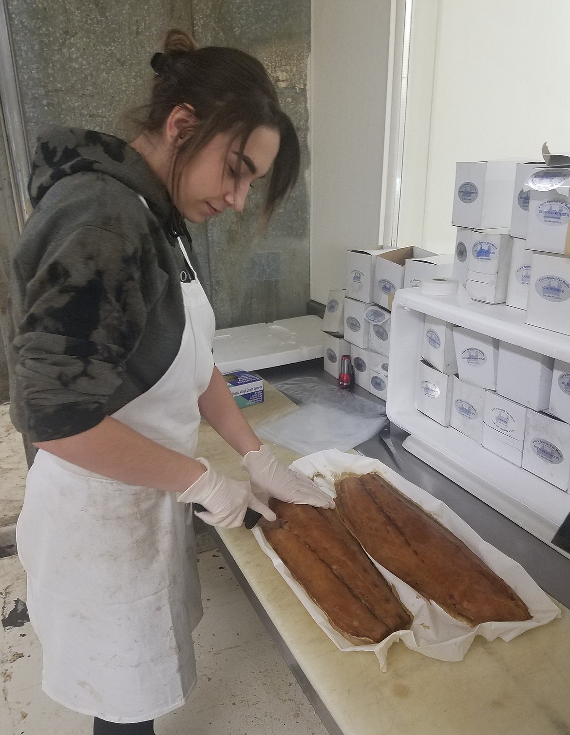 Courtesy photo
Kara Redd, a meat wrapper, office administrator and customer service associate at Tim&#146;s Special Cut Meats, prepares an order. The store is moving this summer to Post Falls.