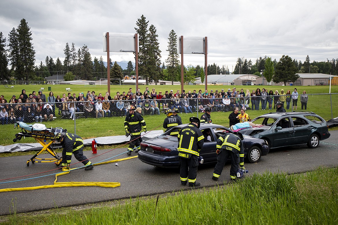 Lakeland High School students watch as law enforcement personnel and firefighters take part in a mock drunk driving crash Friday morning at Lakeland Jr. High School. (LOREN BENOIT/Press)
