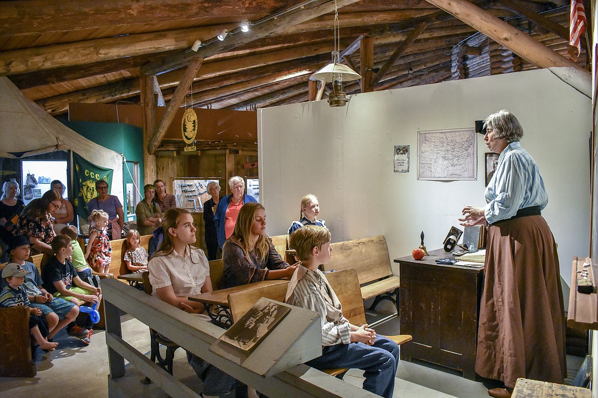 As visitors listen in, retired teacher Kathy Powers leads a re-creation of what school was like in 1901 in Libby during Opening Day for the Libby Heritage Museum in its 40th year on Saturday, June 2. 
(Ben Kibbey/The Western News)