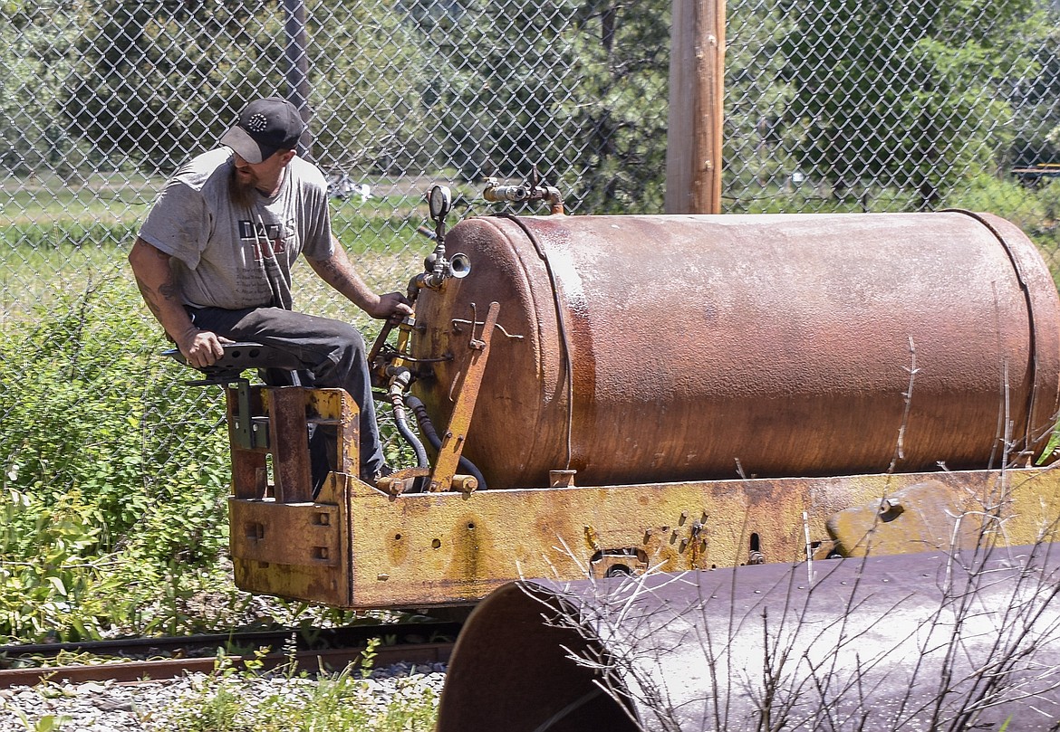 Robert Viergutz, owner and operator of Snap Shot Mining and Milling Co., demonstrates a mine car, powered by compressed air dating back to a time before battery-powered mining machinery. 
(Ben Kibbey/The Western News)