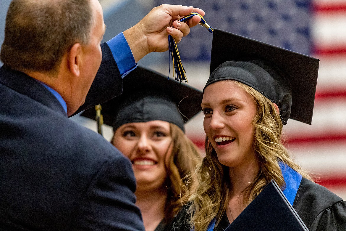 Libby High School Vice Principal Jim Germany flips Maryssa Sanderson&#146;s tassel while Machenna Slinkard awaits her turn after the seniors received their diplomas Saturday, June 2, 2018. 
(John Blodgett/The Western News)