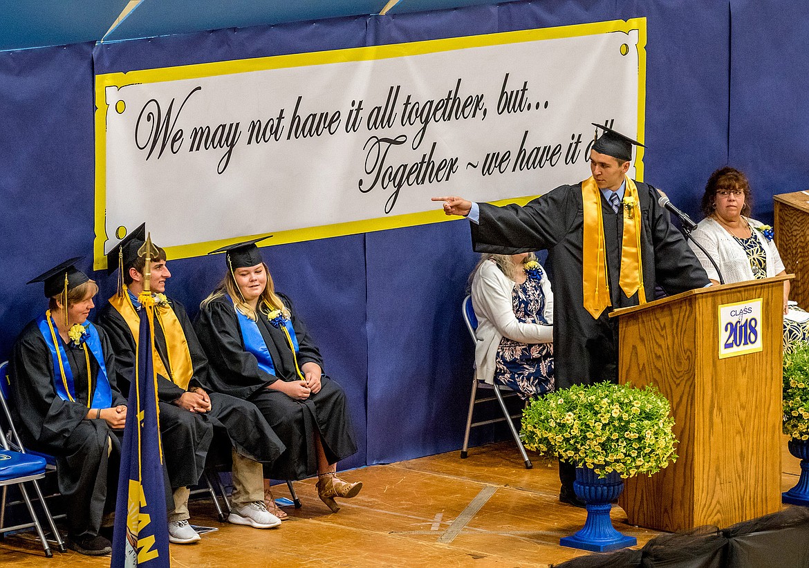 From the podium, Logan Christensen, co-valedictorian of the Libby High School Class of 2018, calls out and points to salutatorian Brian Peck during his address at graduation on Saturday, June 2, 2018. Peck is flanked by co-valedictorian Shannon Reny, left, and Senior Class President Landy Schikora.  
(John Blodgett/The Western News)