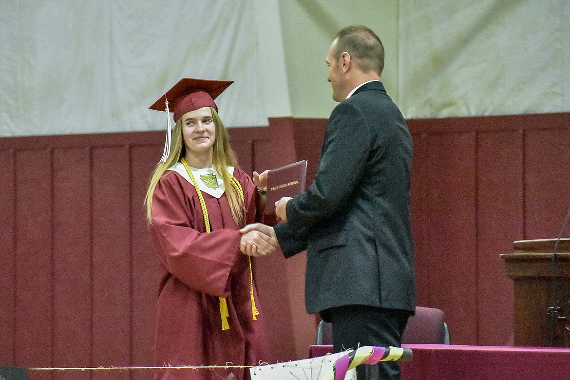 Troy's Sarah Osborn receives her diploma at the Troy School Activity Center auditorium during graduation on Saturday, June 2, 2018. (Ben Kibbey/The Western News)