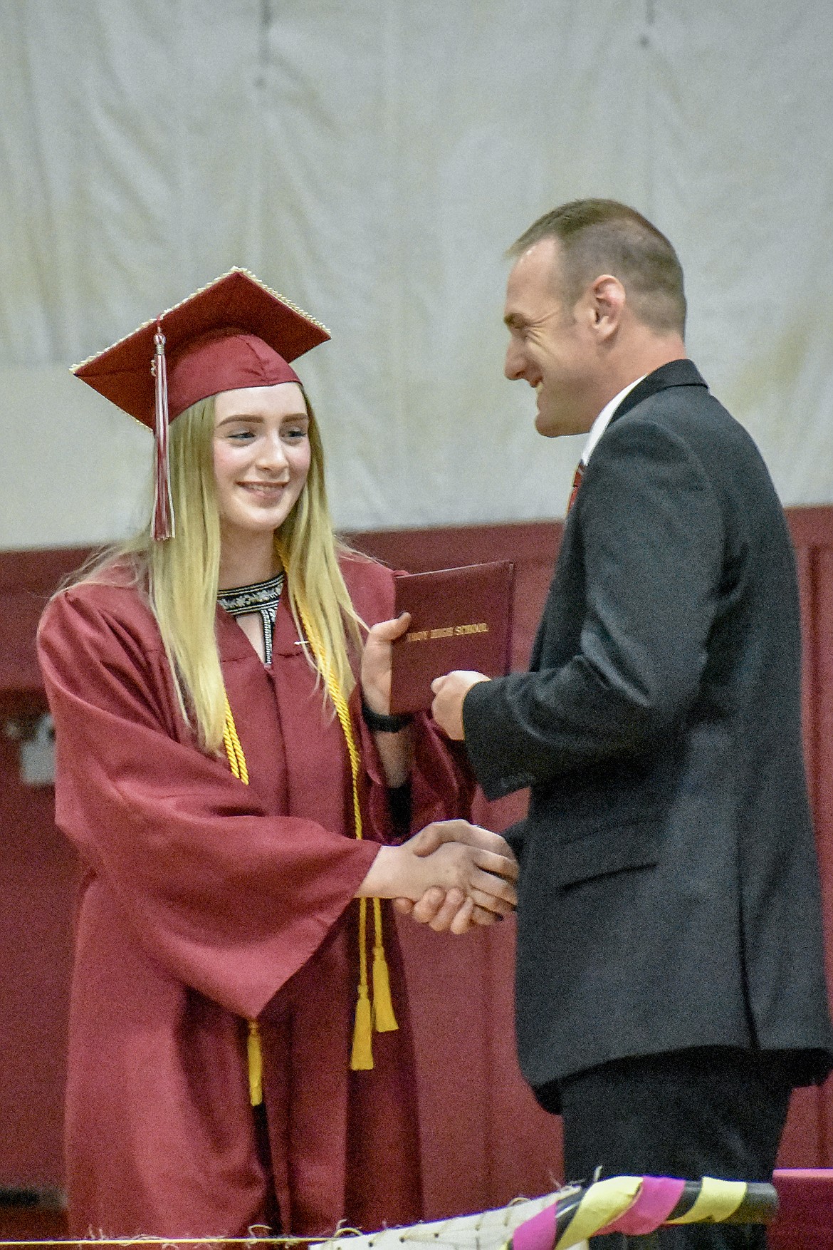 Troy's Grace Dolan receives her diploma at the Troy School Activity Center auditorium during graduation on Saturday, June 2, 2018. (Ben Kibbey/The Western News)