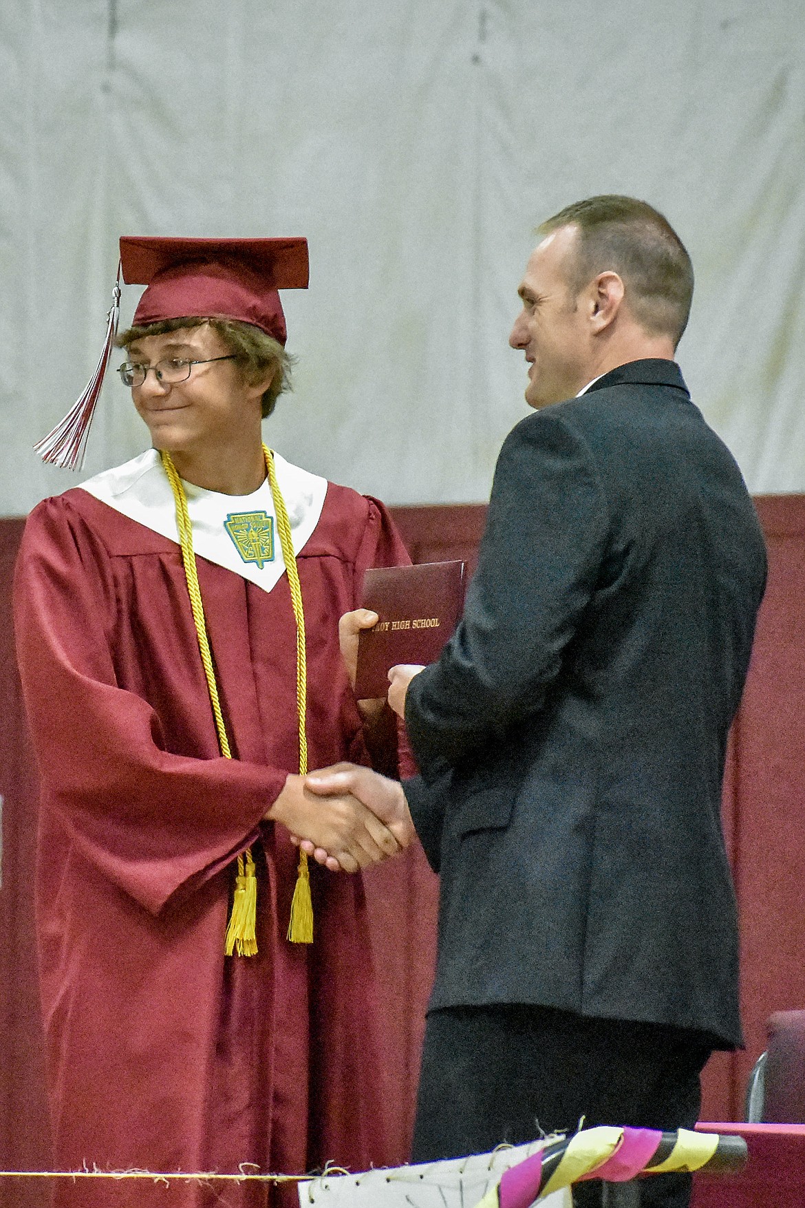 Troy's AJ Faur receives his diploma at the Troy School Activity Center auditorium during graduation on Saturday, June 2, 2018. (Ben Kibbey/The Western News)