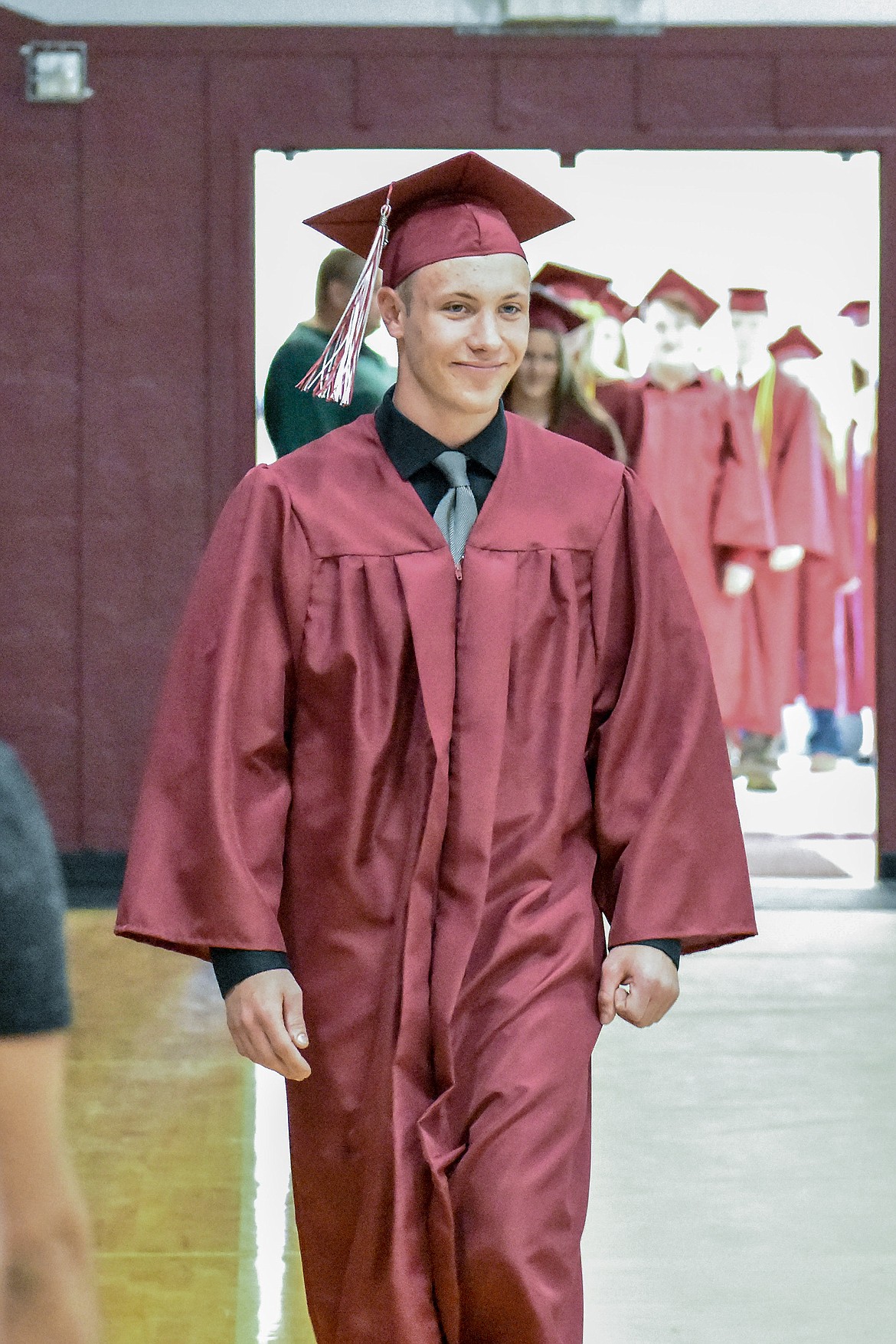 Troy's Zach Burkey enters the Troy School Activity Center auditorium for graduation on Saturday, June 2, 2018.