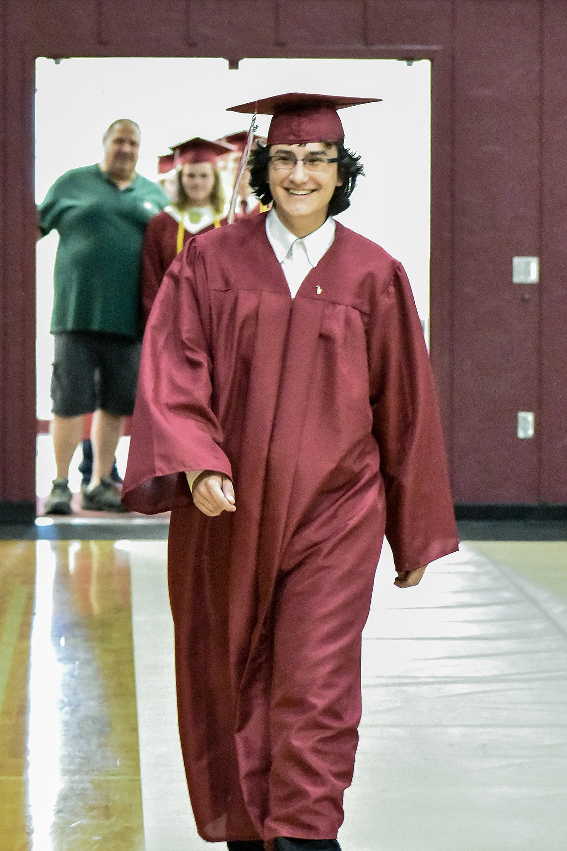 Troy's Liam Hennsley enters the Troy School Activity Center auditorium for graduation on  Saturday, June 2, 2018. (Ben Kibbey/The Western News)