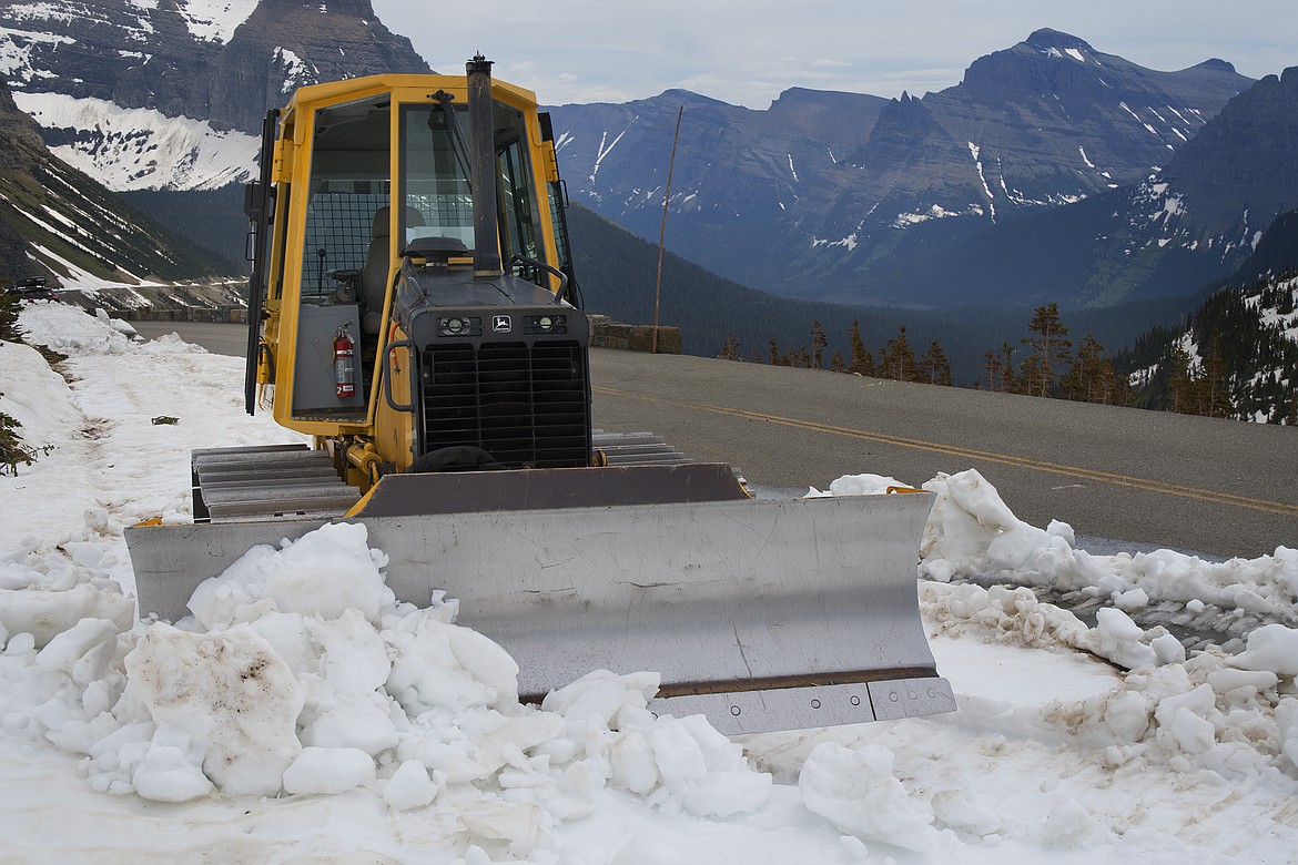 Snow removal teams work near Logan Pass in Glacier National Park Thursday. Snow levels are low, but the park has not yet set an opening date for the Going to the Sun Road. (Jeremy Weber photo)