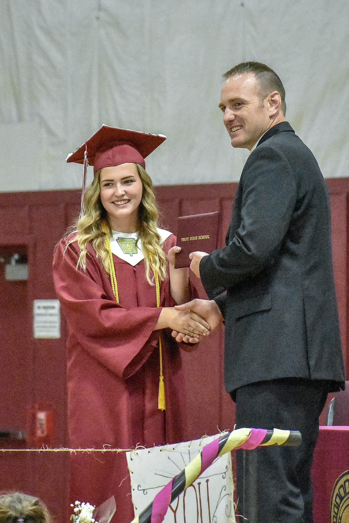 Troy's Kaitlyn Downey receives her diploma at the Troy School Activity Center auditorium during graduation on Saturday, June 2, 2018. (Ben Kibbey/The Western News)