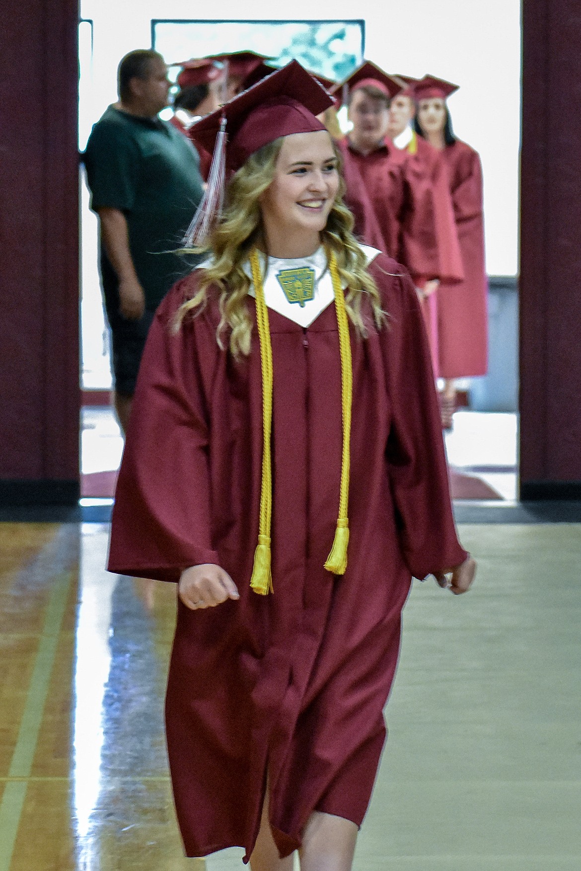 Troy's Kaitlyn Downey  enters the Troy School Activity Center auditorium for graduation on  Saturday, June 2, 2018. (Ben Kibbey/The Western News)