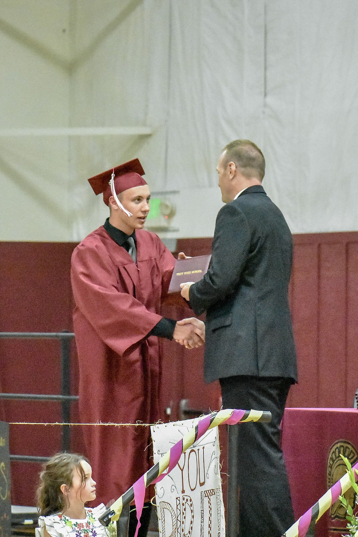 Troy's Zach Burkey receives his diploma at the Troy School Activity Center auditorium during graduation on Saturday, June 2, 2018. (Ben Kibbey/The Western News)