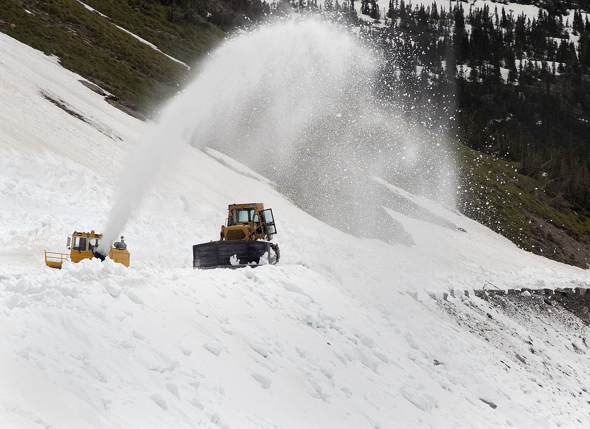 Snow removal teams work near Logan Pass in Glacier National Park Thursday. Snow levels are low, but the park has not yet set an opening date for the Going to the Sun Road. (Jeremy Weber photo)