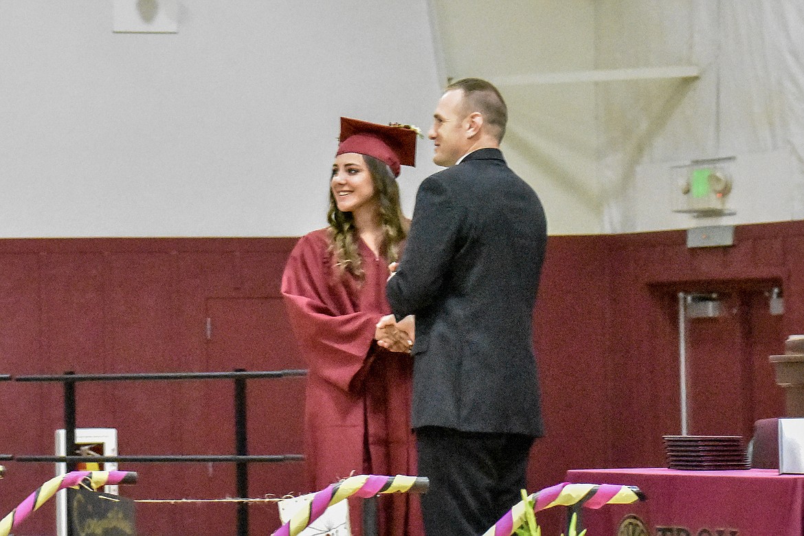 Troy's Aurora Becquart receives her diploma at the Troy School Activity Center auditorium during graduation on Saturday, June 2, 2018. (Ben Kibbey/The Western News)
