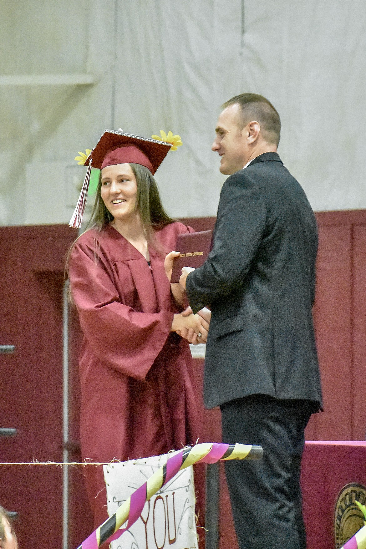Troy's Allie Coldwell receives her diploma at the Troy School Activity Center auditorium during graduation on Saturday, June 2, 2018. (Ben Kibbey/The Western News)