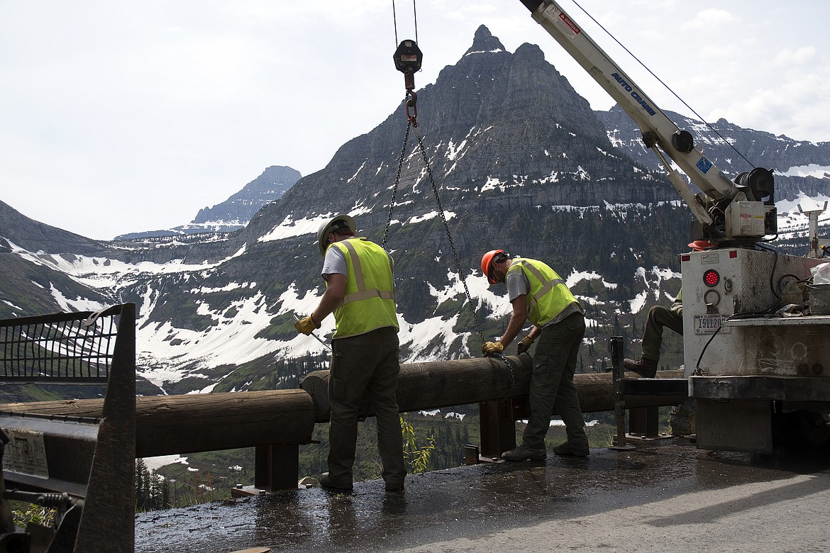 Crews work to install removeable side barriers on the Going to the Sun road Thursday. (Jeremy Weber photo)