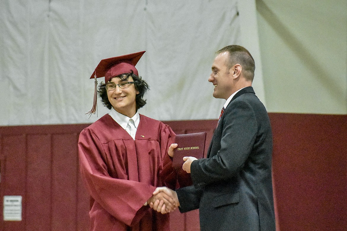 Troy's Liam Hennsley receives his diploma at the Troy School Activity Center auditorium during graduation on Saturday, June 2, 2018. (Ben Kibbey/The Western News)