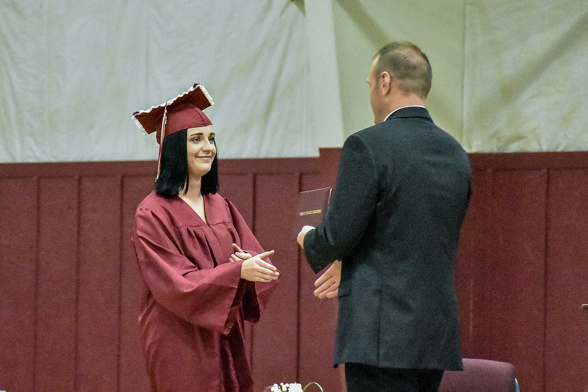Troy's MacKenzie Tallmadge receives her diploma at the Troy School Activity Center auditorium during graduation on Saturday, June 2, 2018. (Ben Kibbey/The Western News)