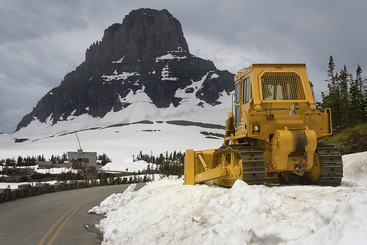 Snow removal teams work near Logan Pass in Glacier National Park Thursday. Snow levels are low, but the park has not yet set an opening date for the Going to the Sun Road. (Jeremy Weber photo)