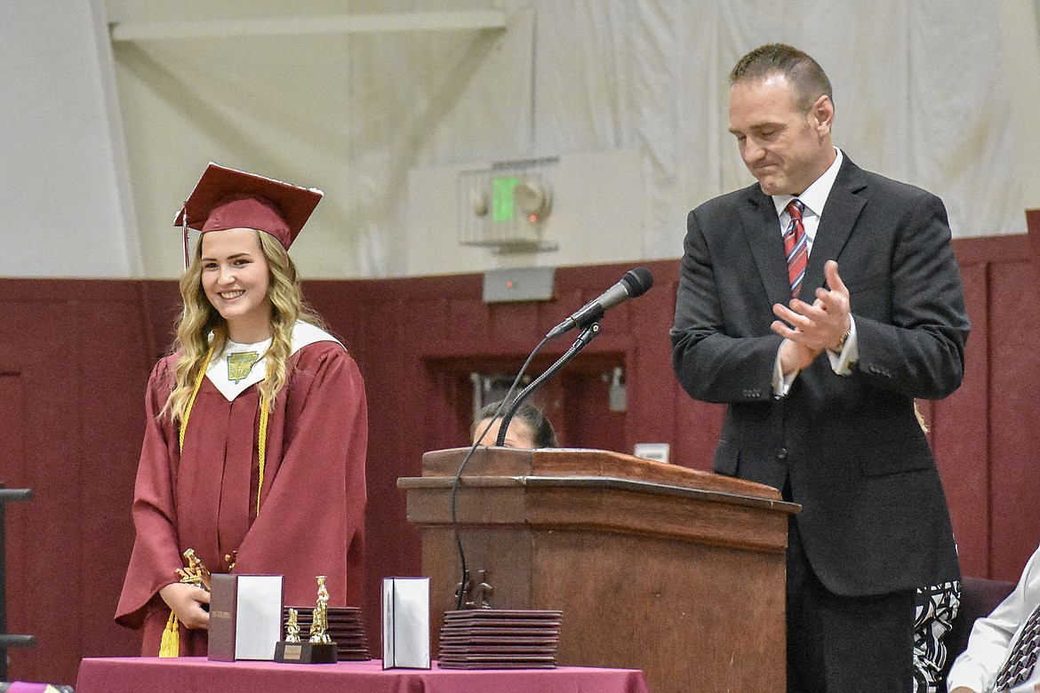 Troy High School Principal Jacob Francome leads a round of applause for class of 2018 Valedictorian Kaitlyn Downey, who will go on to study at the University of Pennsylvania, after listing off her many academic achievements during graduation, Saturday, June 2, 2018. (Ben Kibbey/The Western News)