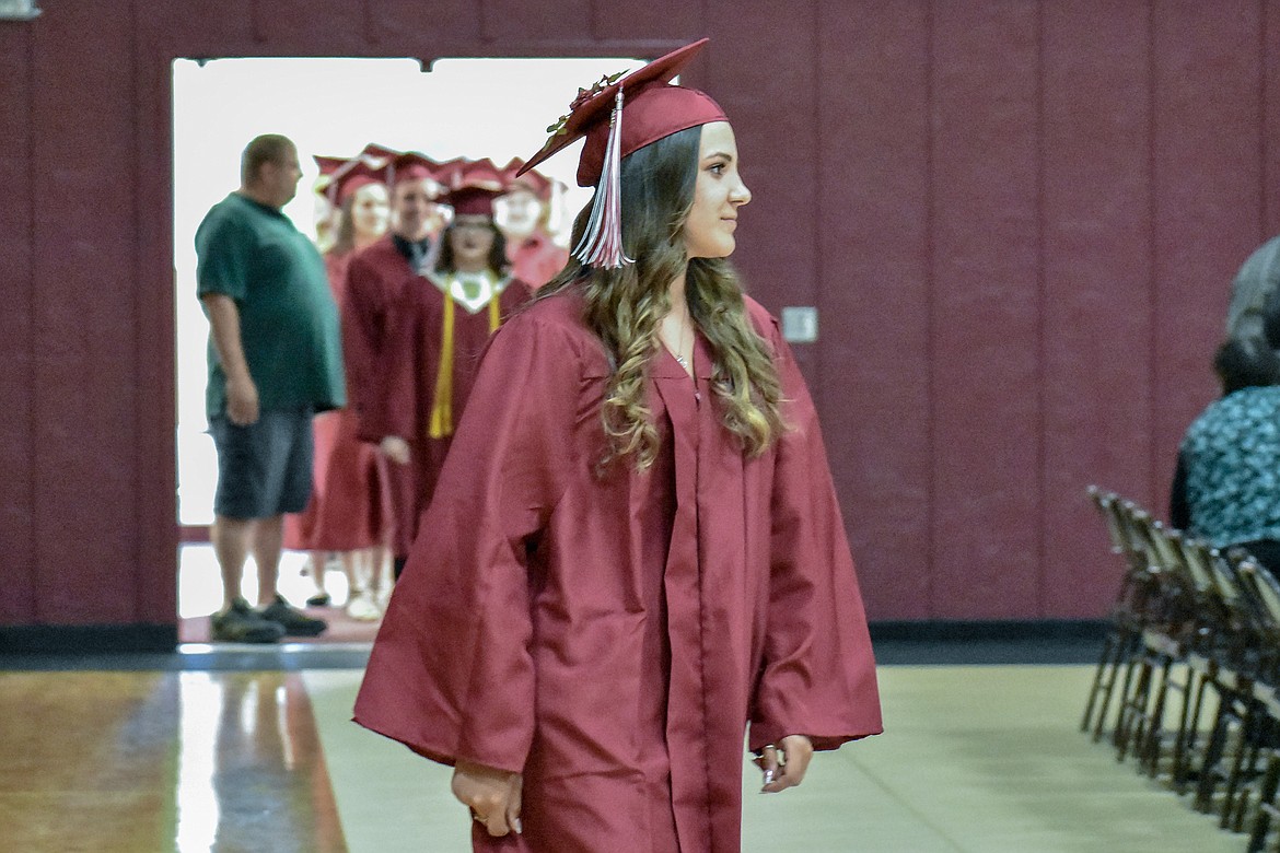 Troy's  Aurora Becquart enters the Troy School Activity Center auditorium for graduation on Saturday, June 2, 2018.