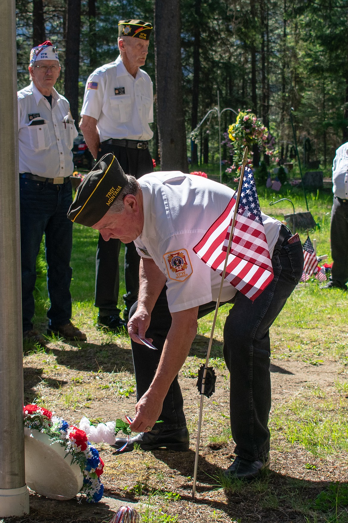 On Monday, VFW John E. Freeman Post 5514 Junior Vice Commander Mike Casey places white flowers symbolizing purity and the hope that, &#147;May each future generation emulate the unselfish courage of all men and women who fought for freedom.&#148; (Ben Kibbey/The Western News)