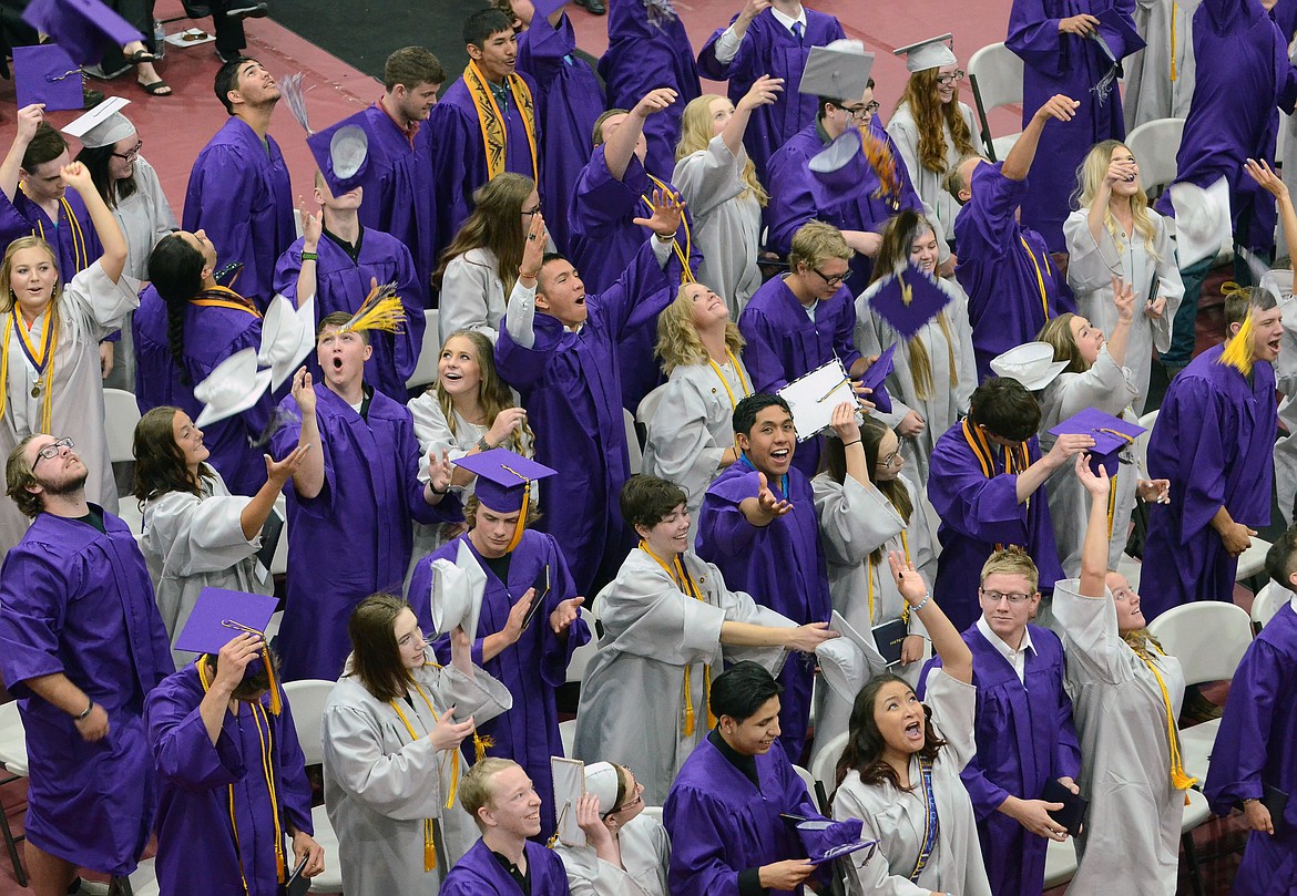 POLSON GRADUATES celebrate their milestone Saturday by throwing their caps in the air after they earn their diplomas. (Jason Blasco/Lake County Leader)