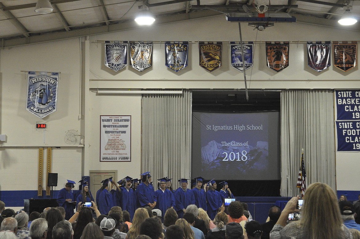 EXCITED FAMILY and friends take photos of the newly graduation seniors at St. Ignatius High School over the weekend. The class of 2018 was the 100th class to graduate from the district. (Ashley Fox/Lake County Leader)