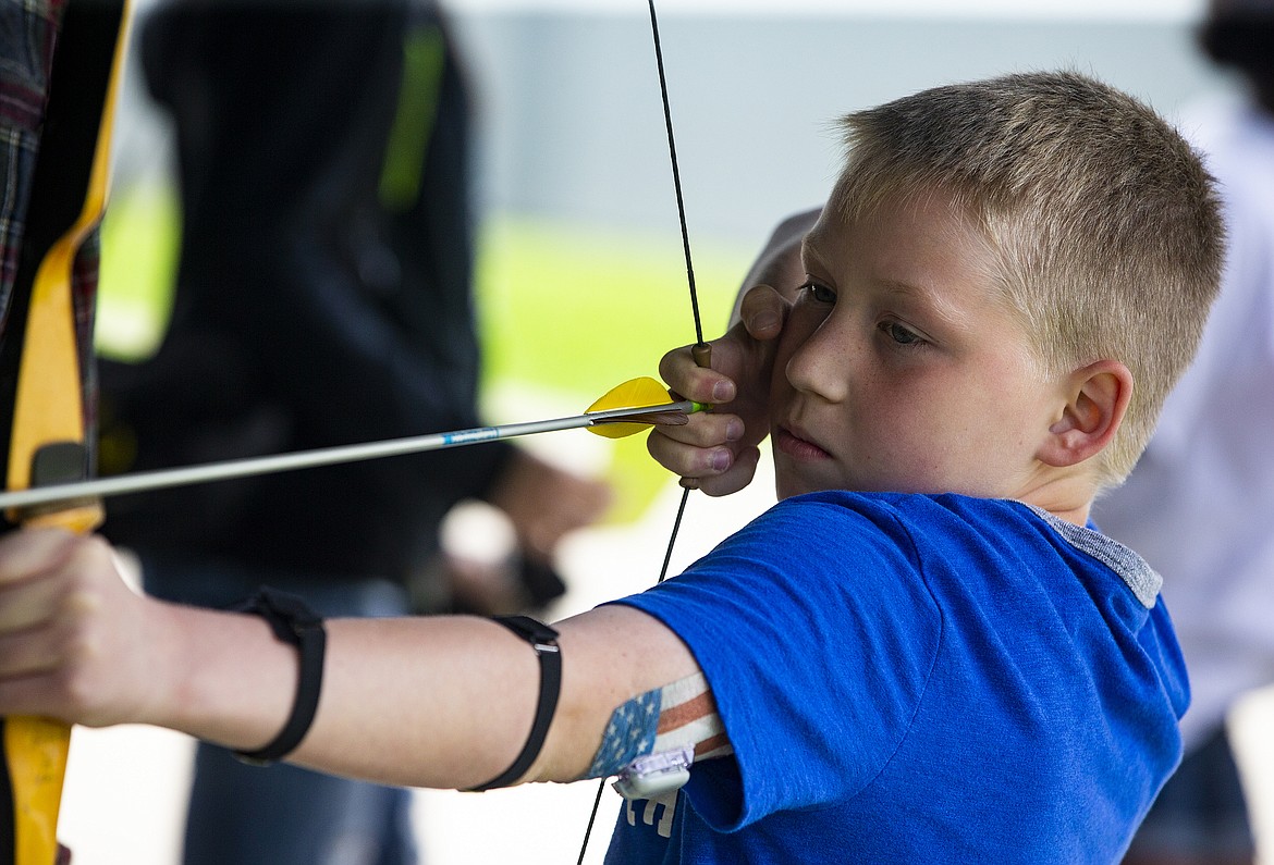 Fourth-grader Logan Bronzini shoots an arrow at the archer station during Ponderosa Elementary School&#146;s Rendevous Day on Thursday. (LOREN BENOIT/Press)