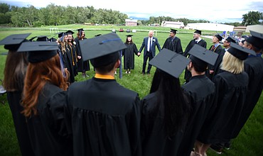 Seniors at Stillwater Christian School gather for a prayer before the start of the commencement ceremony on Friday night, June 1. Twenty three students were awarded their diplomas in the school's 32nd graduating class.(Brenda Ahearn/Daily Inter Lake)