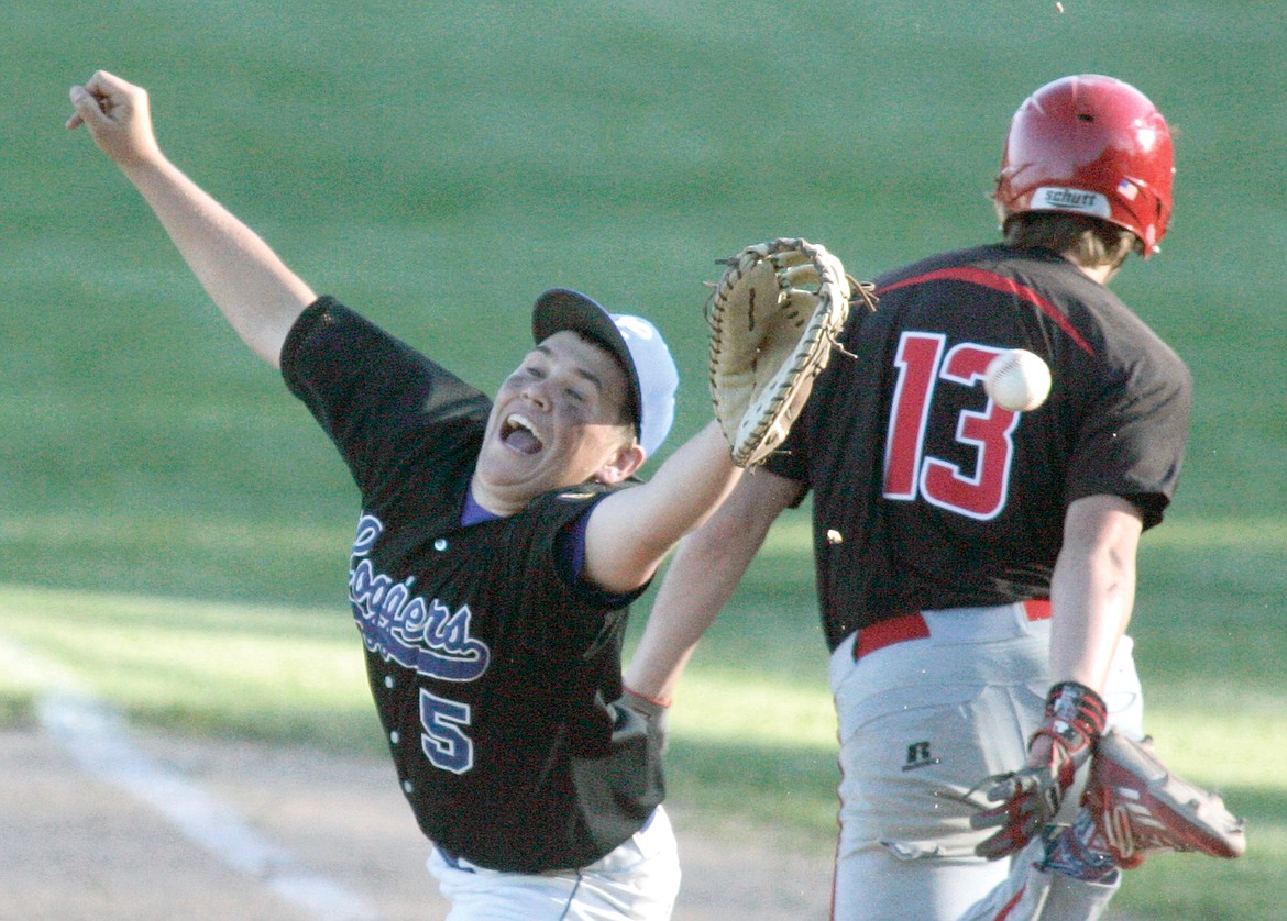 Kalispell&#146;s Ethan Diede reaches first on a bad throw to first baseman Austin McCully top of the sixth inning. (Paul Sievers/The Western News)