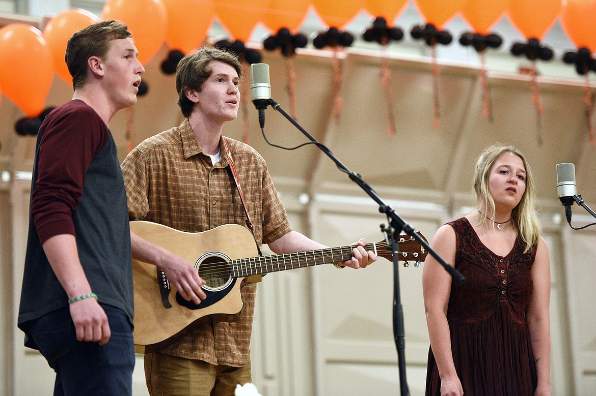 Seniors, from left, Alex Coulter, Jackson Reese and Chloe Archuleta perform the song &quot;Rivers and Roads&quot; by The Head and the Heart at the Flathead High School Class of 2018 Commencement on Friday. (Casey Kreider/Daily Inter Lake)