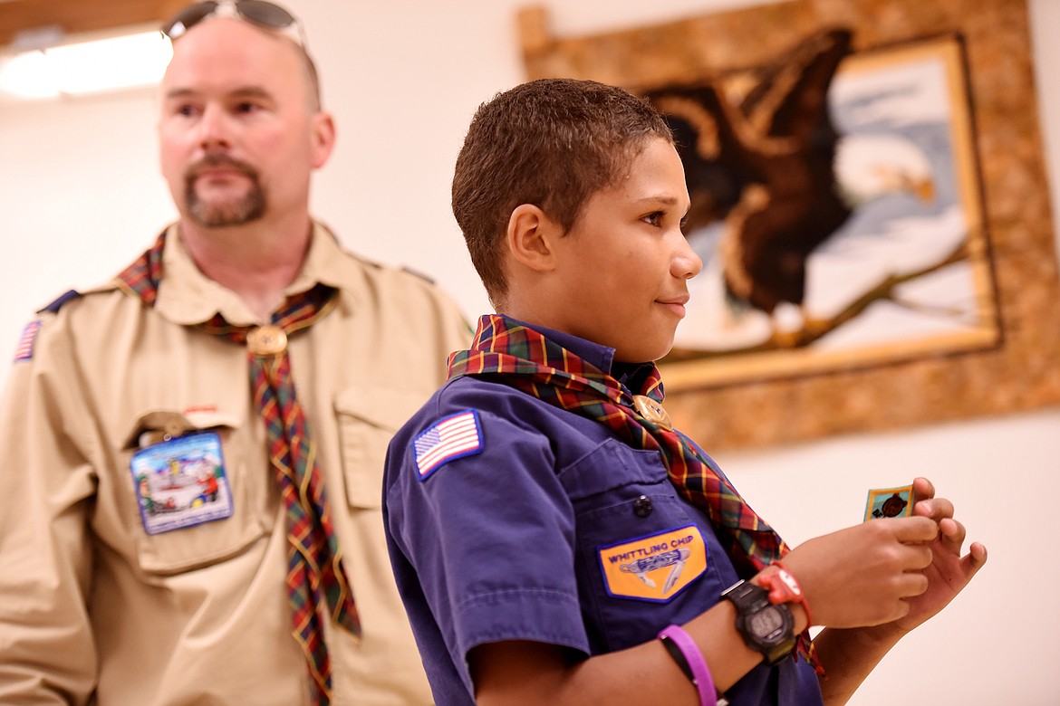 Arya Jepson gets her new scarf from Cubmaster Keri Barr in the Cub Scout Advancement ceremony on Monday, May 21.(Brenda Ahearn/Daily Inter Lake)