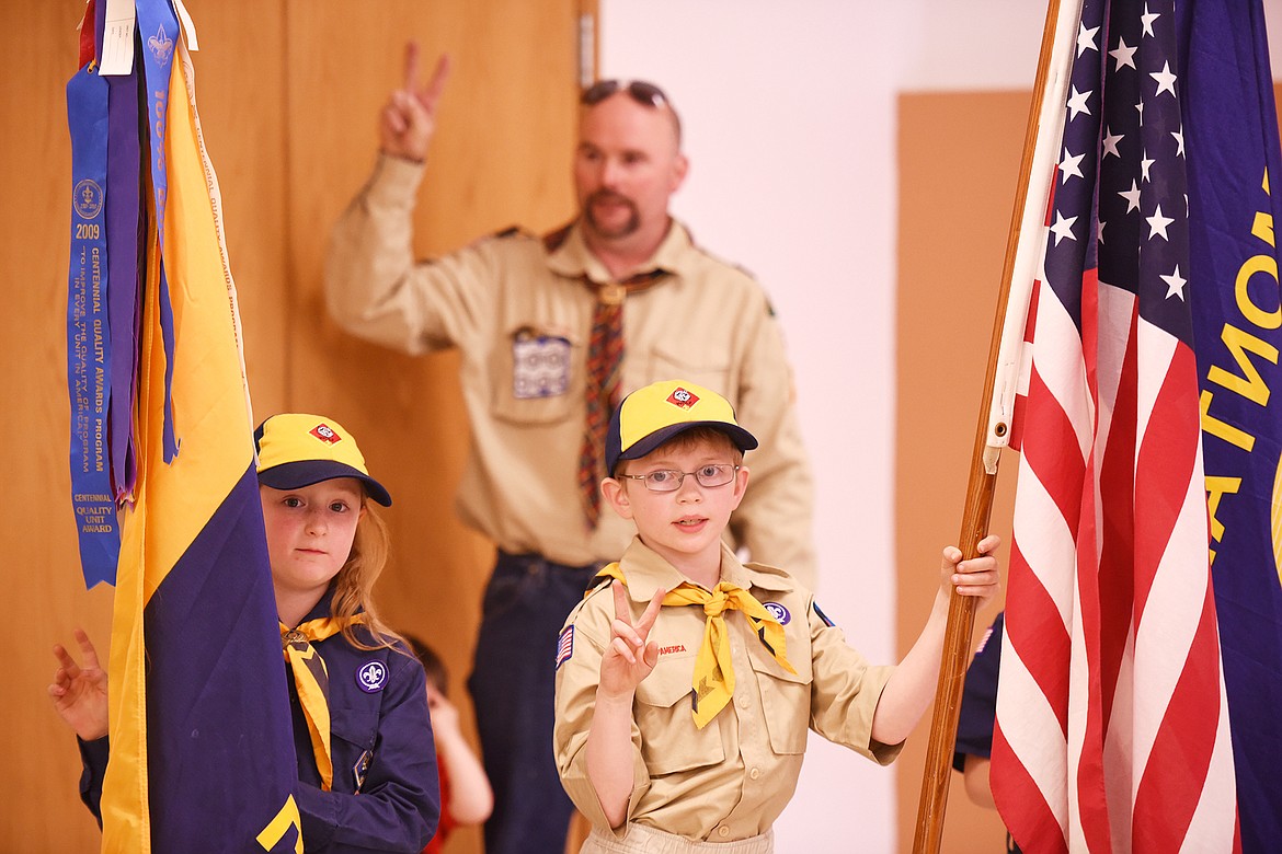 Annie Hartle and Austin Stone hold their hands up reciting the Scout Oath at the start of their advancement ceremony on Monday, May 21, at Bethany Lutheran Church in Bigfork.(Brenda Ahearn/Daily Inter Lake)