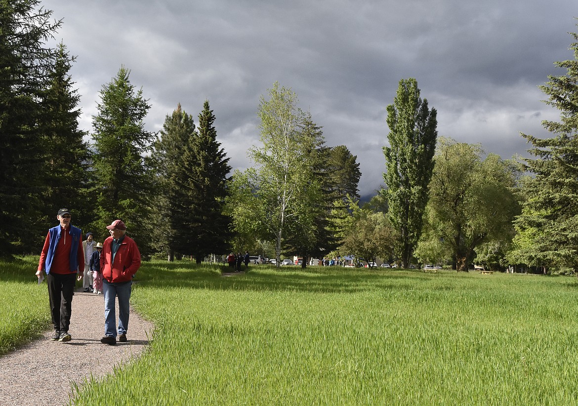 Folks wonder along the path in the James R. Bakke Nature Reserve Friday afternoon following an celebration of the opening of the natural park. (Heidi Desch/Whitefish Pilot)