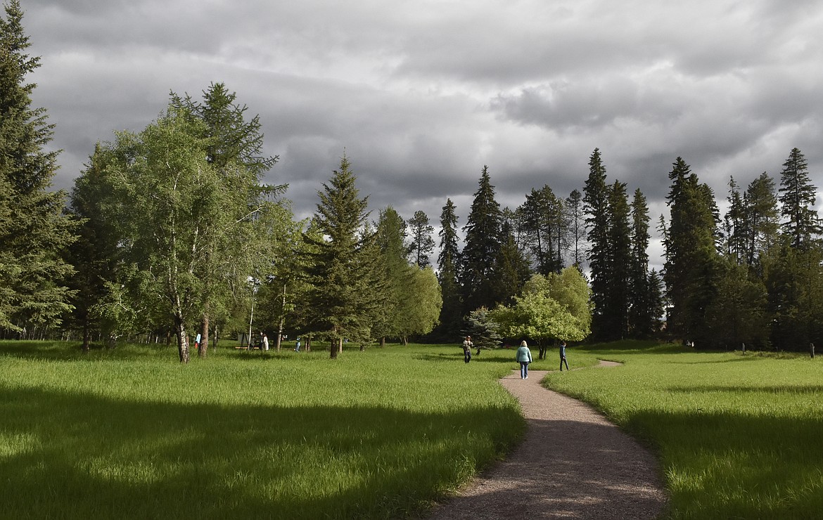 Folks walk along the path in the James R. Bakke Nature Reserve Friday afternoon following an celebration of the opening of the natural park. The reserve is on West Seventh Street. (Heidi Desch/Whitefish Pilot)