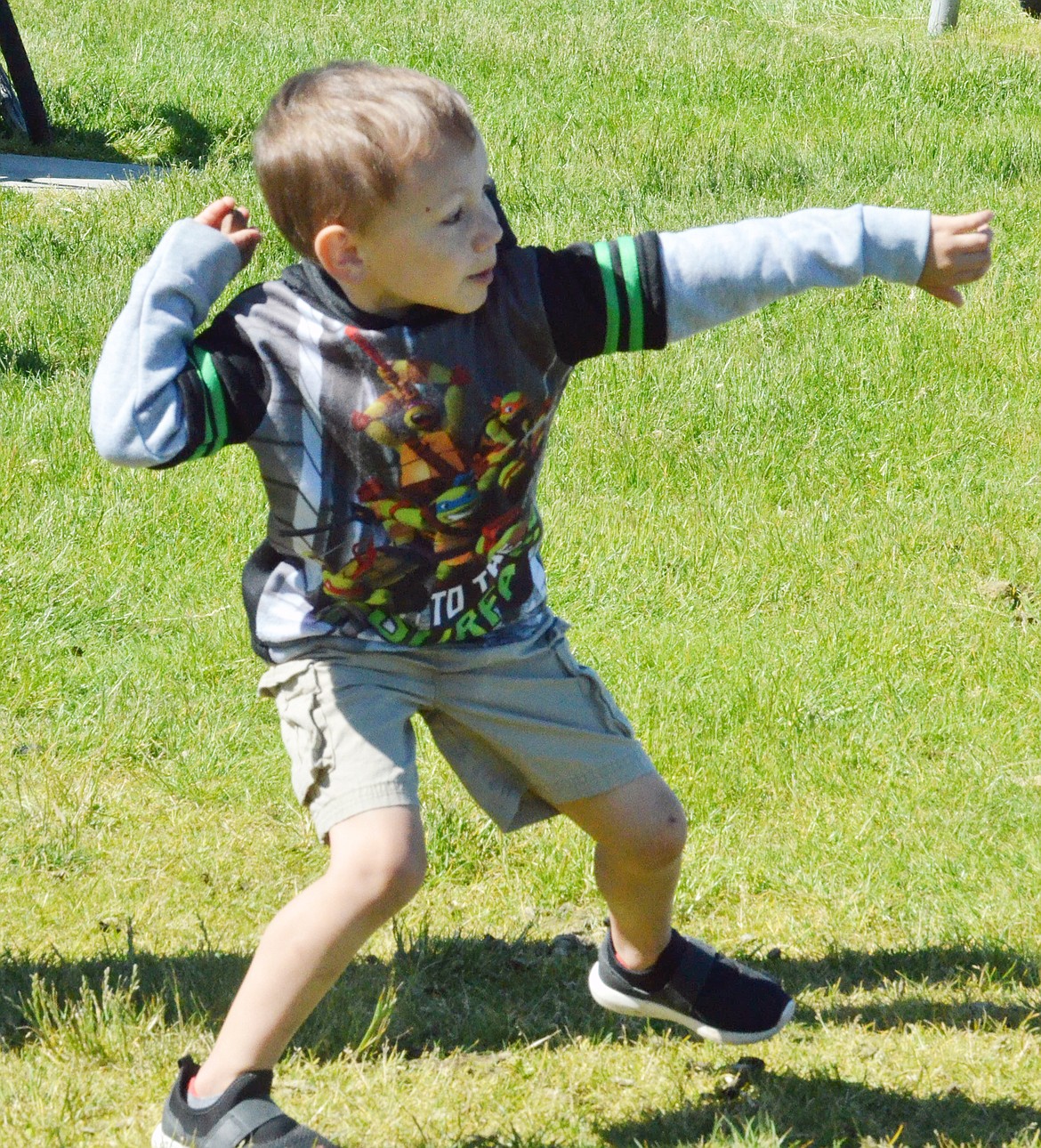 A POLSON rock skipping contestant attempts to skip a rock into the Flathead River Saturday afternoon at Riverside Park. (Jason Blasco/Lake County Leader)