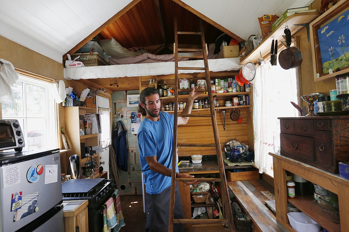 Aaron Castle uses a ladder to reach the sleeping area in his 139-square-foot tiny house on wheels in San Bruno, Calif., on June 3, 2016. As housing prices soar in the Bay Area, a growing number of people are living in tiny houses as a way to save money. (Gary Reyes/Bay Area News Group/TNS)