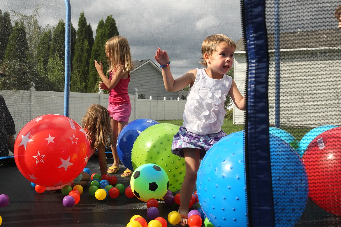 MITCHELL BONDS/Press file
Brystol Lenz, 3, right, bounces on her new trampoline with her sisters Arianna, left, and Adalynn during her wish reveal party in August 2017. Brystol, a kidney cancer survivor, was gifted the trampoline through Make-A-Wish Idaho, an organization dedicated to bringing happiness to children experiencing life-threatening medical conditions. The program is in need of volunteer wish granters, who only need to put in a few hours a month to help make dreams come true.