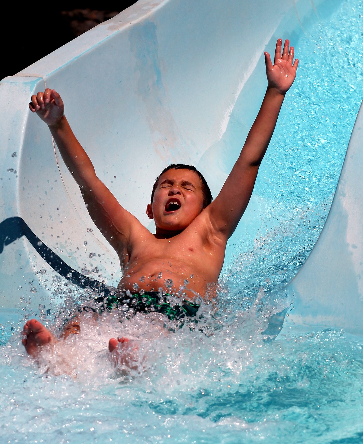 Rodney Harwood/Columbia Basin Herald
Garden Heights third-grader Jacoby DeLeon comes off the big slide Thursday afternoon at Surf &#146;n Slide. He&#146;s also a part of the Explorers Program at the water park.