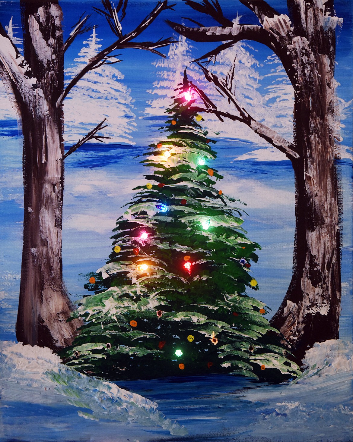 Owner/Artist Ashley Lindemann created this Christmas themed class with lights added to the painting. In her personal artwork Lindemann frequently uses mix-media techniques.(Brenda Ahearn/Daily Inter Lake)