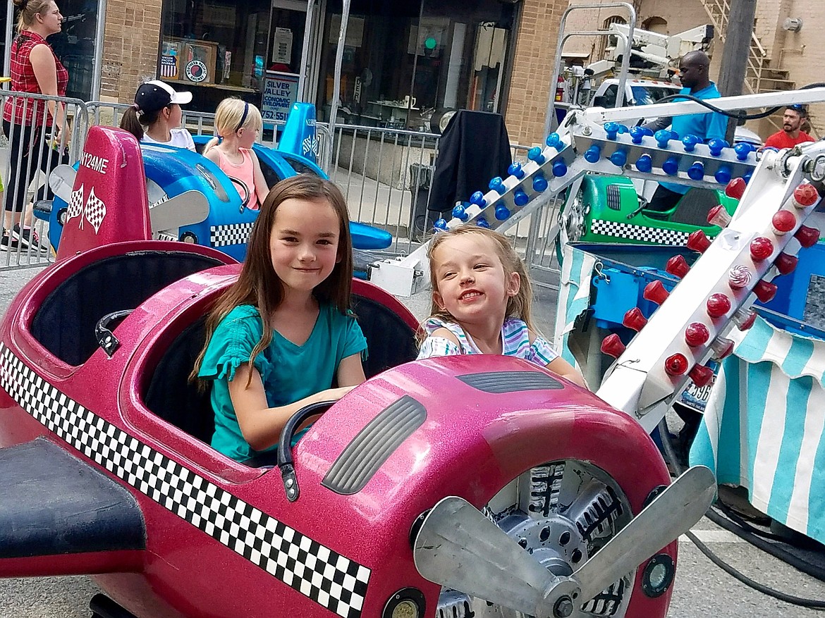 Photo courtesy of LAURIE HURD
Delena (front) and Destiny Hurd enjoy the carnival rides in Wallace during Gyro Days.