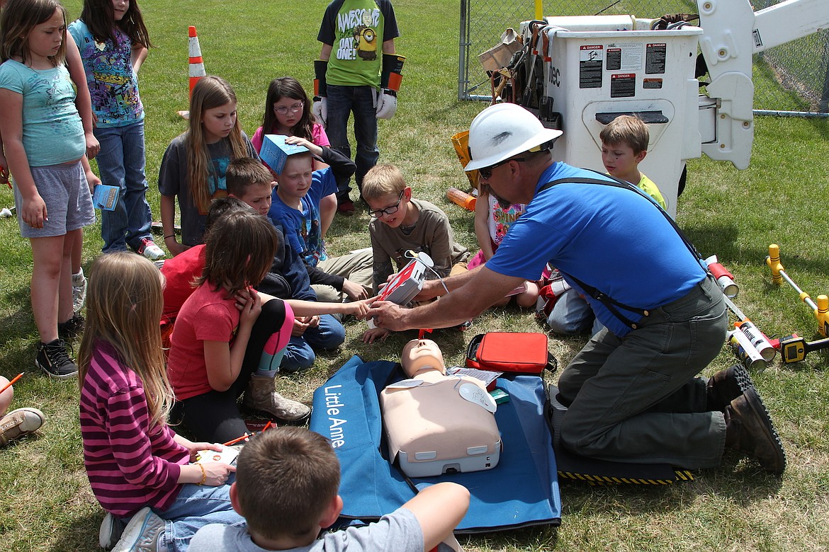 (Photo by KEITH KINNAIRD)
Chad Summers, an Avista lineman and local representative, demonstrates CPR during Idaho Hill's Safety Day.