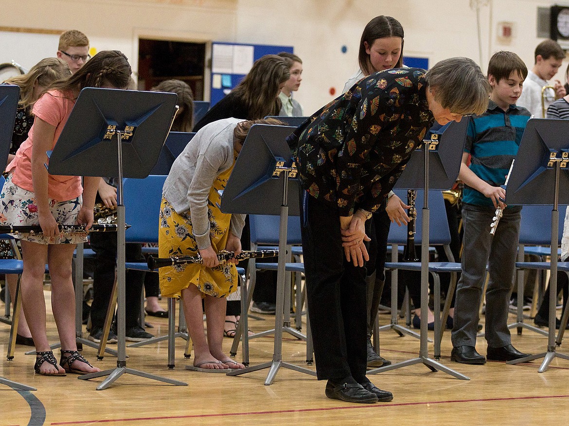 Band Director Brenda Nagode, foreground, and the sixth grade band take a bow after performing on March 27. (John Blodgett/The Western News)