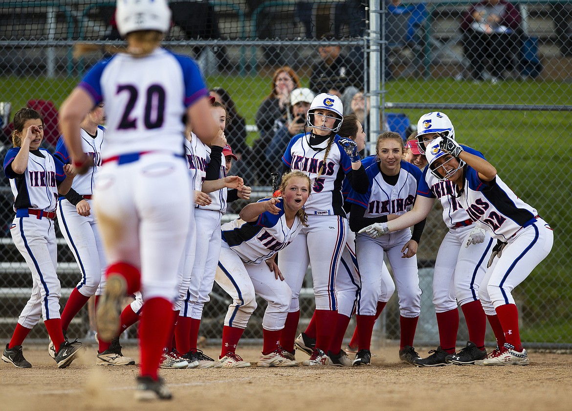 The Coeur d&#146;Alene High softball team greets Hailey Lyons at home plate after she hit a home run against Lake City on May 1.